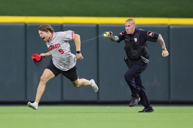 An unidentified fan is tased by a police officer as he runs on the field before the ninth inning of the Cincinnati Reds against Cleveland Guardians at Great American Ball Park on June 11, 2024 in Cincinnati, Ohio. (Photo by Andy Lyons/Getty Images)