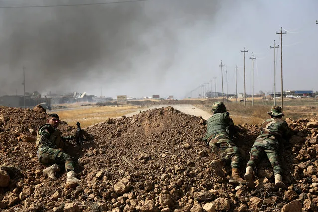 Kurdish security forces take up a position as they fight overlooking the Islamic State-controlled in villages surrounding Mosul, in Khazer, about 30 kilometers (19 miles) east of Mosul, Iraq, Monday, October 17, 2016. Iraqi government and Kurdish forces, backed by U.S.-led coalition air and ground support, launched coordinated military operations early on Monday as the long-awaited fight to wrest the northern city of Mosul from Islamic State fighters got underway. (Photo by AP Photo)