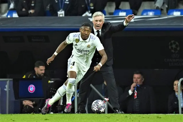 Real Madrid's David Alaba runs with the ball near Real Madrid's head coach Carlo Ancelotti, background, during the Champions League quarter final first leg soccer match between Real Madrid and Chelsea at Santiago Bernabeu stadium in Madrid, Wednesday, April 12, 2023. Real Madrid won 2-0. (Photo by Jose Breton/AP Photo)