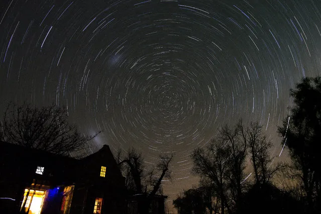 A long exposure image shows star trails on a cold winter night above the farmhouse of Woodford Truffle farm, Groenfontein in the Koue Bokkeveld, South Africa, 16 September 2015. (Photo by Nic Bothma/EPA)
