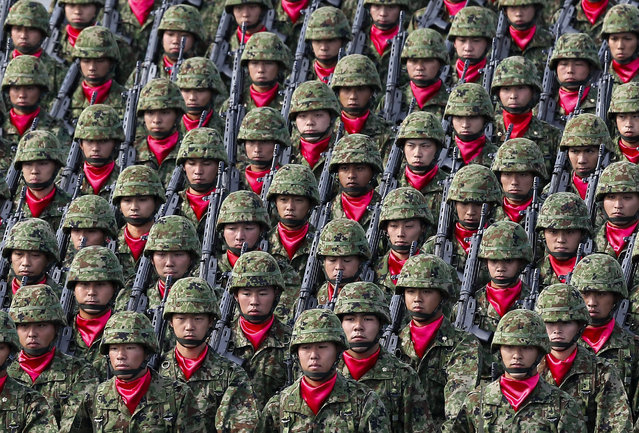 Japanese Ground Self Defense Force's military personnels march during a military parade at the Ground Self Defence Force's Asaka training ground in Asaka, Saitama Prefecture, north of Tokyo, Japan, 23 October 2016. Some 40,00 troops, 280 military tanks and vehicles participated in the annual Japan's Self-Defense Forces parade. (Photo by Kimimasa Mayama/EPA)