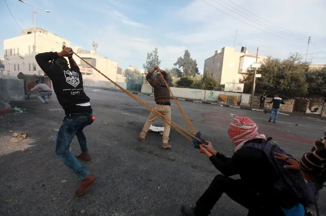 Palestinian protesters use a large slingshot to hurl stones towards Israeli troops during clashes in the West Bank city of Bethlehem November 27, 2015. (Photo by Abdelrahman Younis/Reuters)