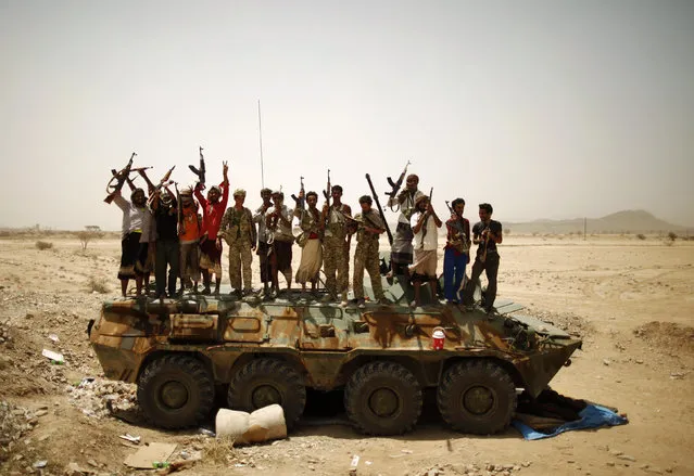 Members of Yemen's elite Republican Guard and pro-army tribesmen gather for a group photo atop a military vehicle as they secure a road leading to Lawdar town in the southern province of Abyan June 19, 2012. (Photo by Khaled Abdullah/Reuters)