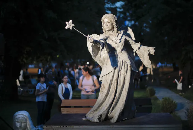 In this Tuesday, May 22, 2018, photograph, an artist of The Netherlands' Levend Theater performs the Angel character during the Living Statues International Festival, in Bucharest, Romania. (Photo by Vadim Ghirda/AP Photo)