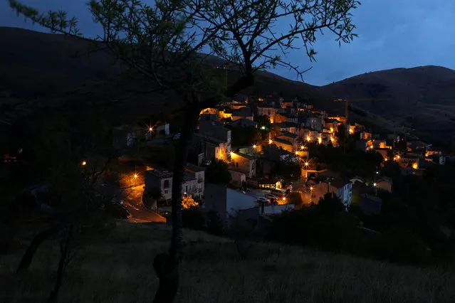 The town of Santo Stefano di Sessanio is pictured at dusk, in the province of L'Aquila in Abruzzo, inside the national park of the Gran Sasso e Monti della Laga, Italy, September 5, 2016. (Photo by Siegfried Modola/Reuters)