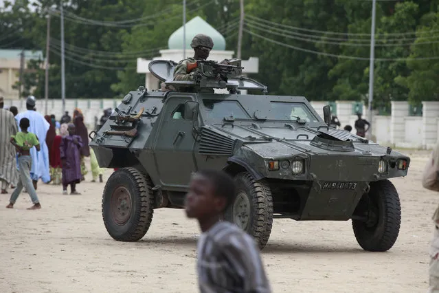 In this Thursday, August 8, 2013 file photo, Nigerian soldiers ride on an armored personnel carrier during Eid al-Fitr celebrations in Maiduguri, Nigeria.  Nigeria's army said Saturday November 5, 2016, it has rescued one Chibok schoolgirl who was kidnapped by Boko Haram Islamic extremists more than two-years ago in a raid on a forest hideout.  Spokesman Col. Sani Kukasheka Usman said Saturday, the schoolgirl was found with a 10-month old baby boy. (Photo by Sunday Alamba/AP Photo)