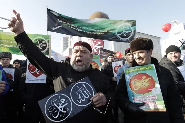 People attend a rally to protest against satirical cartoons of prophet Mohammad, in Grozny, Chechnya January 19, 2015. The poster (L) reads, “Allah” and “Mohammad” and the one on the right reads, “Mohammad”. (Photo by Eduard Korniyenko/Reuters)