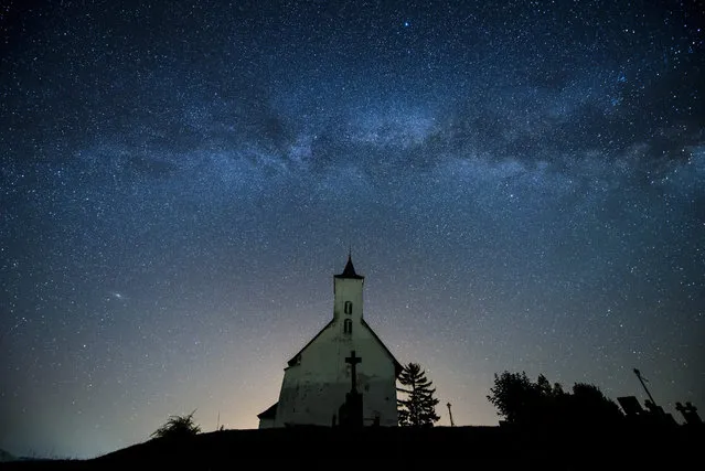 A picture made available on 30 June 2016 shows a church silhouetted below a belt of the Milky Way at the Hungarian-Slovakian border village Gemersky Jablonec, or Gomoralmagy in Hungarian, in southern Slovakia, 29 June 2016. (Photo by Peter Komka/EPA)