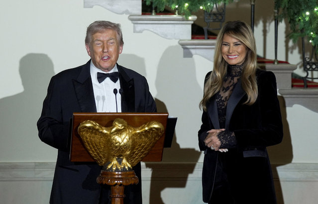 U.S. President Donald Trump speaks next to first lady Melania Trump during the Congressional Ball in the Grand Foyer at the White House in Washington, D.C., U.S. December 11, 2025. (Photo by Al Drago/Reuters)