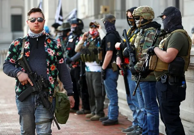 Protest leader Mike Dunn and other armed demonstrators take part in a pro-gun rally in Richmond, Virginia, U.S. November 21, 2020. (Photo by Hannah McKay/Reuters)