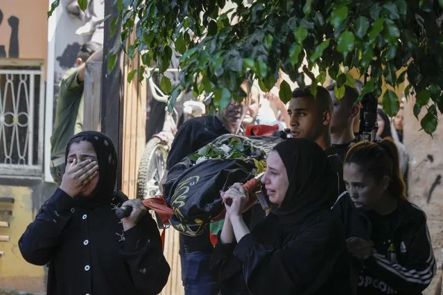 The classmates of 15-year-old Sadeel Naghniyeh carry her body during her funeral in the West Bank Jenin refugee camp, Wednesday, June 21, 2023, Naghniyeh died from wounds sustained in an Israeli military raid on Monday that triggered some of the fiercest fighting with Palestinian militants in years. (Photo by Majdi Mohammed/AP Photo)