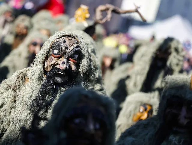 Men in costumes and traditional masks take part in the Schleicherlaufen festival in the western Austrian town of Telfs February 1, 2015. (Photo by Dominic Ebenbichler/Reuters)