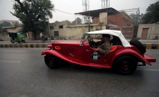 A man drives his classic car during the 7th Vintage Classic Car Rally as they pass through Peshawar, Pakistan November 20, 2016. (Photo by Fayaz Aziz/Reuters)