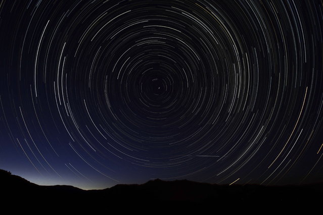 A multiple exposure picture taken in the early hours of August 11, 2013 shows a Perseids meteor shower in the sky, near the municipality of La Hiruela, on the mountains of the Sierra Norte de Madrid. (Photo by Dani Pozo/AFP Photo)