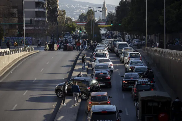 Cars are caught in a traffic jam as protesters block a main road that links the Lebanese capital Beirut to the southern suburbs, Wednesday, March 17, 2021. (Photo by Hassan Ammar/AP Photo)