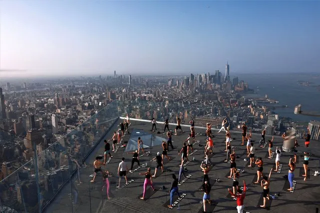 People take part in a “Sky-High” yoga session on Manhattan’s Edge in New York City, U.S., July 26, 2023. (Photo by Amr Alfiky/Reuters)
