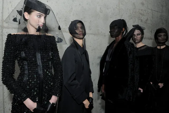 Models pose for photographs before the Thom Browne Fall 2015 collection is shown during New York Fashion Week, Monday, February 16, 2015. (Photo by Diane Bondareff/AP Photo)