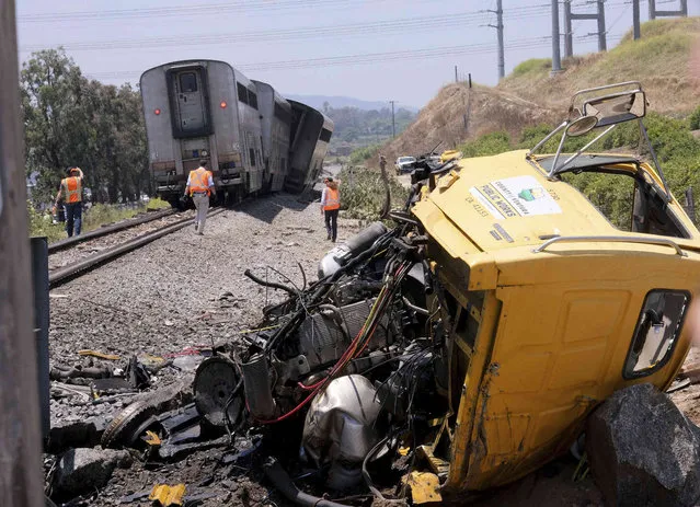 A destroyed truck lies next to a derailed Amtrak train in Moorpark, Calif., on Wednesday, June 28, 2023. Authorities say an Amtrak passenger train carrying 190 passengers derailed after striking a vehicle on tracks in Southern California. Only minor injuries were reported. (Photo by Dean Musgrove/The Orange County Register via AP Phoot)