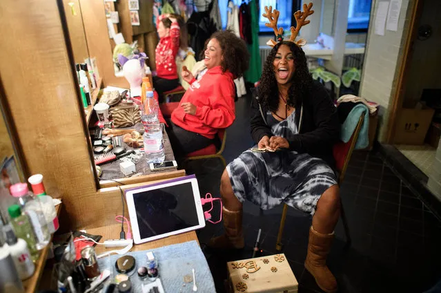 Alexia Khadime (R) prepares for her role as Princess Tahlia, ahead of a performance of the traditional pantomime “Sleeping Beauty” at the Hackney Empire on December 13, 2016 in Hackney, England. The show runs from November 26, 2016 to January 8, 2017, with many days having two performances. A pantomime is a musical comedy stage show, traditionally performed around the Christmas period for families, with many moments of audience interaction and regular characters appearing, no matter the story. These can include a gender reversal where “The Dame”, a major female character, is played by a man, and the part of lead “boy” is filled by a young actress. (Photo by Leon Neal/Getty Images)