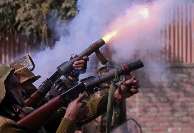 Indian policemen fire teargas shells towards demonstrators during a protest near the site of a gun battle between Indian security forces and suspected militants in Nowgam, on the outskirts of Srinagar, October 24, 2018. (Photo by Danish Ismail/Reuters)