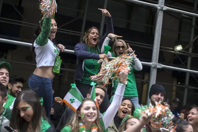 Spectators cheer as they watch the 254th New York City St. Patrick's Day parade march up 5th Avenue in the Manhattan Borough of New York, March 17, 2015. (Photo by Mike Segar/Reuters)