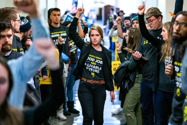 Supporters of Representative elect Ocasio-Cortez's proposed Select Committee on a “green New Deal” rally outside the office of Democratic Congressman from Maryland and House Minority Whip Steny Hoyer in the Longworth House Office Building in Washington, DC, USA, 10 December 2018. The rally was organized by Sunrise, a “movement to stop climate change and create millions of good jobs in the process”. Dozens of activists were arrested during their action. (Photo by Jim Lo Scalzo/EPA/EFE)