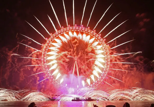 Fireworks light up the sky over the London Eye in central London during the New Year celebrations on January 1, 2019. (Photo by Yui Mok/PA Images via Getty Images)