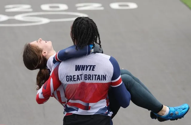 Kye Whyte of Team Great Britain carries Bethany Shriever of Team Great Britain after winning Gold during the Men's Cycling BMX Racing Semifinal on Day 7 of the Tokyo 2020 Olympic Games at Ariake Urban Sports Park on July 30, 2021 in Tokyo, Japan. (Photo by Christian Hartmann/Reuters)
