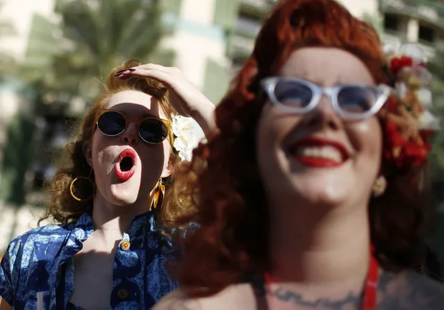 In this April 3, 2015, photo, Chelsea Spirito, left, reacts as she watches a men's bathing suit contest at the Viva Las Vegas Rockabilly Weekend in Las Vegas. Mae La Roux is on the right. (Photo by John Locher/AP Photo)