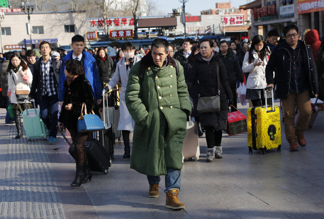 Passengers walk towards Beijing Railway Station during the travel rush ahead of the upcoming Spring Festival in Beijing, China, February 4, 2016. (Photo by Kim Kyung-Hoon/Reuters)