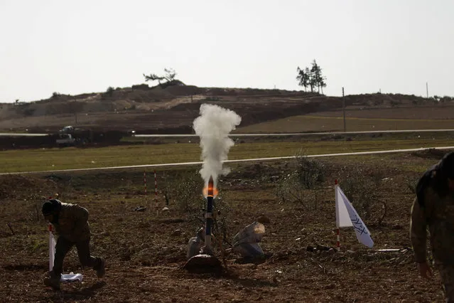 Rebel fighters shoot a rocket towards the northern Syrian town of al-Bab, Syria January 7, 2017. (Photo by Khalil Ashawi/Reuters)