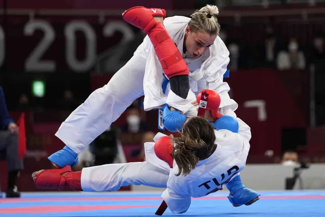 Silvia Semeraro of Italy, top, and Meltem Hocaoglu Akyol of Turkey compete in the women's kumite +61kg elimination round for karate at the 2020 Summer Olympics, Saturday, August 7, 2021, in Tokyo, Japan. (Photo by Vincent Thian/AP Photo)