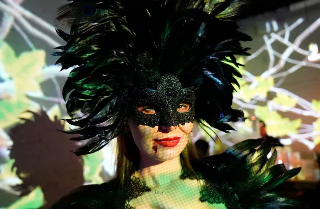 A person attends The McKittrick Halloween Ball: The Lost Garden, in the Chelsea neighborhood of New York City on October 29, 2022. The ball is held over three nights. Completed in 1939, the McKittrick Hotel is a now 5-story pseudo hotel (warehouse) that was converted to hold eclectic interactive performances. (Photo by Timothy A. Clary/AFP Photo)