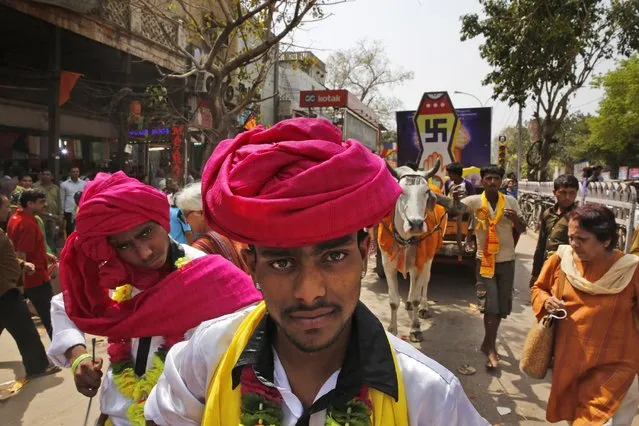 Indian folk artists participate in a procession to mark Mahavir Jayanti, a religious festival celebrated by Jains to commemorate the birth anniversary of Lord Mahavira, in New Delhi, India, Thursday, April 2, 2015. Mahavira, is the last of twenty-four Teerthankaras (Jain Prophets) and has been acclaimed as one of the supreme teachers and a social reformer.(Photo by Manish Swarup/AP Photo)