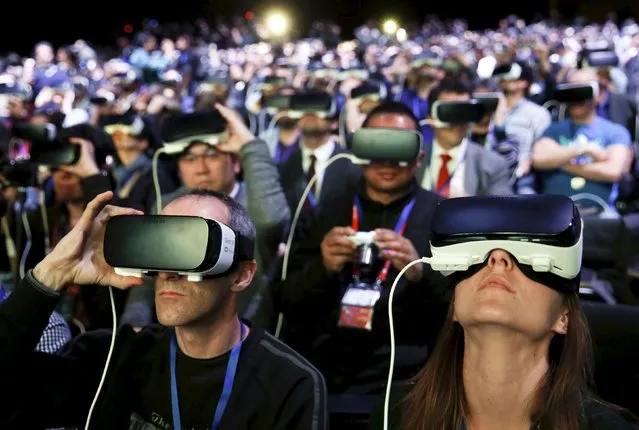 People wear Samsung Gear VR devices as they attend the launching ceremony of the new Samsung S7 and S7 edge smartphones during the Mobile World Congress in Barcelona, Spain, February 21, 2016. (Photo by Albert Gea/Reuters)