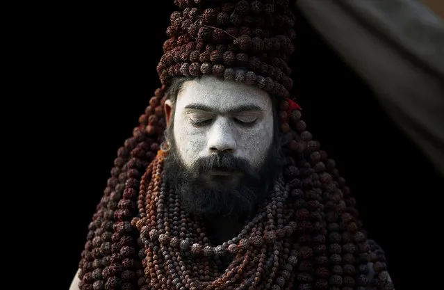 A Naga Sadhu or Hindu holy man waits for devotees inside his camp during “Kumbh Mela” or the Pitcher Festival, in Prayagraj, previously known as Allahabad, India, February 2, 2019. (Photo by Adnan Abidi/Reuters)
