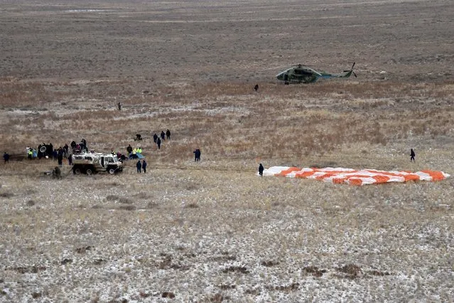 Members of a search and rescue team work at the site of landing of the Soyuz TMA-18M spacecraft, which carried International Space Station (ISS) crew members U.S. astronaut Scott Kelly, Russian cosmonauts Sergei Volkov and Mikhail Korniyenko near the town of Dzhezkazgan (Zhezkazgan), Kazakhstan, March 2, 2016. (Photo by Kirill Kudryavtsev/Reuters)