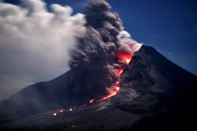 Sinabung volcano spews hot ash and lava in Karo on January 14, 2014. More than 25,000 people have fled their homes following a series of eruptions and lava flows from Sinabung volcano in North Sumatra, an official said on January 12. (Photo by Sutanta Aditya/AFP Photo)