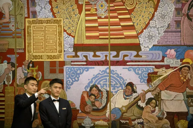 Attendants gesture as they prepare before a group discussion session held on the sidelines of the annual meeting of China's National People's Congress (NPC) in the Tibet Hall of the Great Hall of the People in Beijing, Wednesday, March 6, 2019. The Chinese Communist Party chief for Tibet said on Wednesday that the Dalai Lama has not done a “single good thing” for the region. (Photo by Mark Schiefelbein/AP Photo)