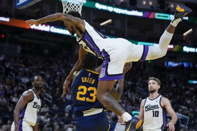 Golden State Warriors forward Draymond Green (23) is fouled by Sacramento Kings guard Malik Monk during the second half of an NBA basketball game Thursday, January 25, 2024, in San Francisco. (Photo by Godofredo A. Vásquez/AP Photo)