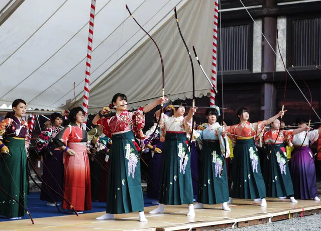 Participants shoot arrows wearing “Furisode”, a long sleeved kimono, take part in an archery event for 20-year-olds to celebrate their coming-of-age at Sanjusangendo Temple on January 17, 2016 in Kyoto, Japan. Some 2,000 people took part in the annual event. (Photo by Taro Karibe/Getty Images)