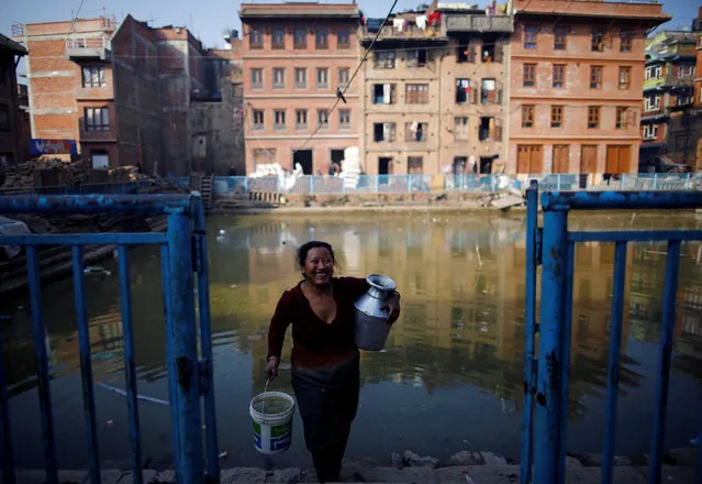 A woman smiles as she returns after fetching water from a pond in Bhaktapur, Nepal January 10, 2017. (Photo by Navesh Chitrakar/Reuters)