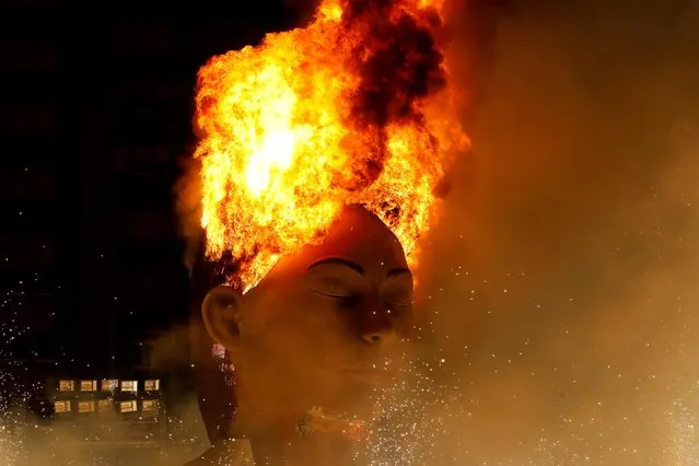 A figure of the municipal Falla, “La meditadora”, burns during the end of the Fallas Festival, which had to be postponed until September due to the restrictions in place during the coronavirus pandemic, in Valencia on September 5, 2021. (Photo by Eva Manez Lopez/Reuters)