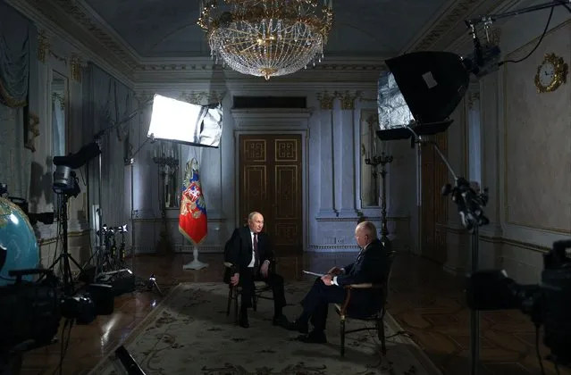 In this pool photograph distributed by Russia's state agency Sputnik, Russian President Vladimir Putin gives an interview to TV host and Director General of Rossiya Segodnya (RIA Novosti) news agency Dmitry Kiselyov at the Kremlin in Moscow on March 12, 2024. (Photo by Gavriil Grigorov/Pool via AFP Photo)