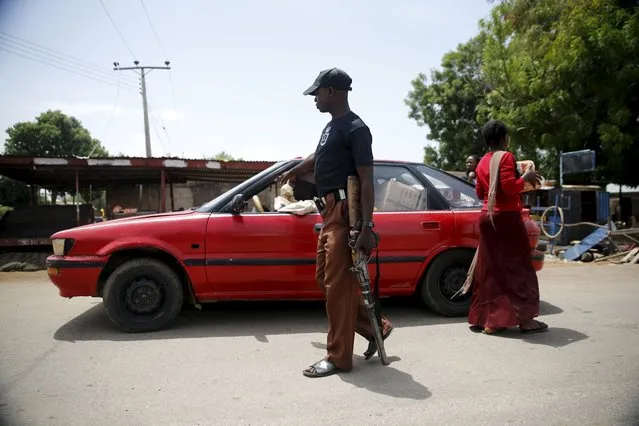 A local vigilante checks a vehicle at a check point in Michika town, after the Nigerian military recaptured it from Boko Haram, in Adamawa state May 10, 2015. (Photo by Akintunde Akinleye/Reuters)