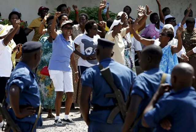 Women sing and dance in front of police during a protest by women against president Pierre Nkurunziza in Bujumbura, Burundi, May 10, 2015. (Photo by Goran Tomasevic/Reuters)