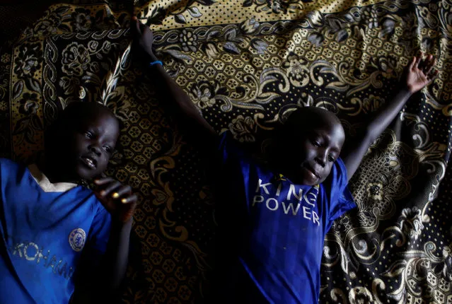 Ruai Mario, 10 (L) and his brother  Machiey Mario, 8, rest on a bed in their home at the United Nations Mission in South Sudan (UNMISS) Protection of Civilian site (CoP) in Juba, South Sudan, February 15, 2017. (Photo by Siegfried Modola/Reuters)