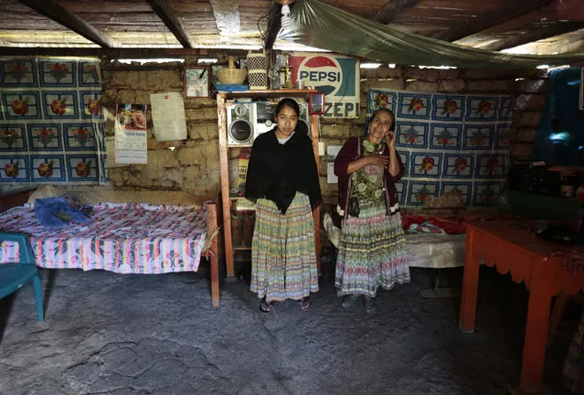 Alicia Chiquin, 43, and her daughter Fidelina Ja, 18, pose for a photograph at their home in Pambach, Guatemala February 20, 2014. Alicia has no education and has always worked the land. Her daughter Fidelina also has no education and when she grows up she says she will continue to work at home and on the land. (Photo by Jorge Dan Lopez/Reuters)