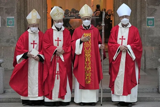Stephen Chow, second right, wearing surgical mask to protect against the coronavirus, poses after the episcopal ordination ceremony as the new Bishop of the Catholic Diocese, in Hong Kong, Saturday, December 4, 2021. The new head of Hong Kong's Catholic diocese expressed hope Saturday that he could foster healing in a congregation and a city divided by the continuing fallout from massive anti-government protests in 2019. (Photo by Kin Cheung/AP Photo)