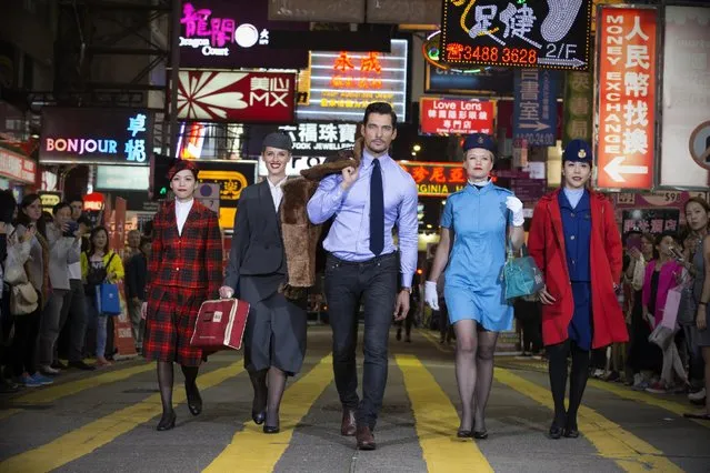 In this handout image provided by British Airways, Supermodel David Gandy takes part in an impromptu British Airways heritage fashion show on the streets of Hong Kong wearing a 1920s Imperial Airways sheepskin pilot jacket to mark the 80th Anniversary of British Airways flights to Hong Kong on April 7, 2016 in Hong Kong. (Photo by British Airways via Getty Images)